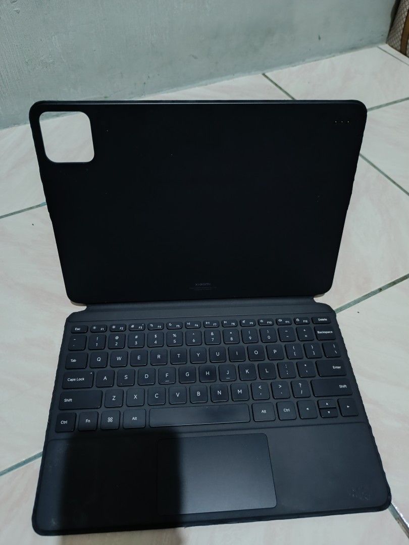 Xiaomi Pad Keyboard Case with Trackpad (Category: Computer Keyboard) located in Manila. Submitted by nothingtosay_00 (Listing ID 1470679293, Image 1). Description: - Compatible with Xiaomi tablet (check model for fit) - Built-in trackpad with standard QWERTY layout - Magnetic fold design protects both screen and back - Convenient camera cutout for the rear camera module - Condition: Shows slight scuffs on the outer cover, otherwise in good workin