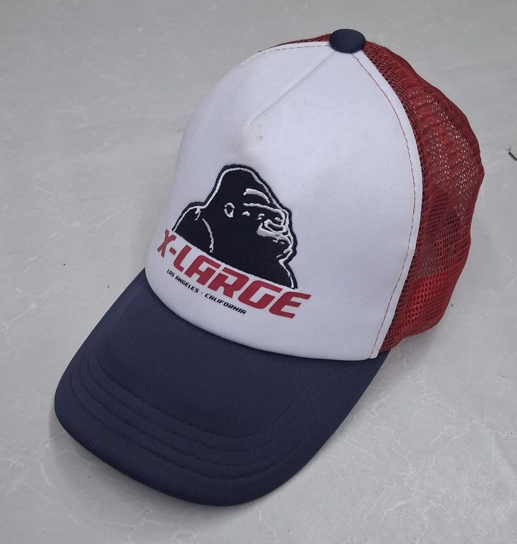 X-Large Trucker Hat Red White Blue Gorilla Logo (Category: Caps & Hats) located in Pasay City. Submitted by al1son18 (Listing ID 1470696915, Image 1). Description: - Size: X-Large with adjustable snapback closure - Design: Iconic gorilla logo with 'Los Angeles California' text on front - Colors: White front panel, dark blue curved brim and top button - Breathability: Red mesh back for all-day comfort.