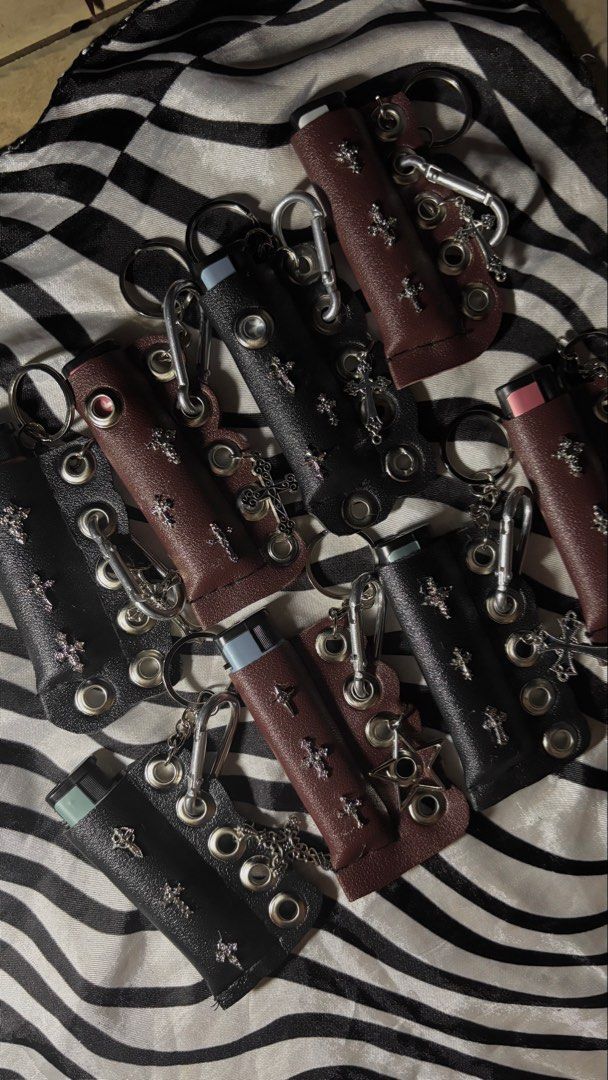 Y2K Goth Cross Leather Lighter Case Keychain (Category: Luxury Accessories) located in Manila. Submitted by bernabeclo75042 (Listing ID 1470603195, Image 1). Description: - Edgy leather lighter case with handmade details - Features metal grommets and cross charms for a grunge/punk aesthetic - Includes a secure keyring and clip to attach anywhere - Snug fit for standard disposable lighters - Available in 2 colors: Black and Maroon 300 php comes wi