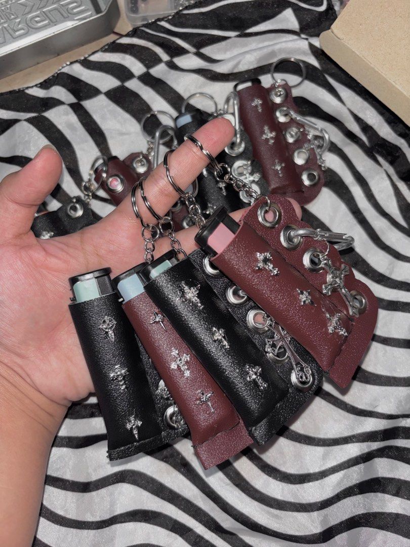 Y2K Goth Cross Leather Lighter Case Keychain (Category: Luxury Accessories) located in Manila. Submitted by bernabeclo75042 (Listing ID 1470603195, Image 2). Description: - Edgy leather lighter case with handmade details - Features metal grommets and cross charms for a grunge/punk aesthetic - Includes a secure keyring and clip to attach anywhere - Snug fit for standard disposable lighters - Available in 2 colors: Black and Maroon 300 php comes wi