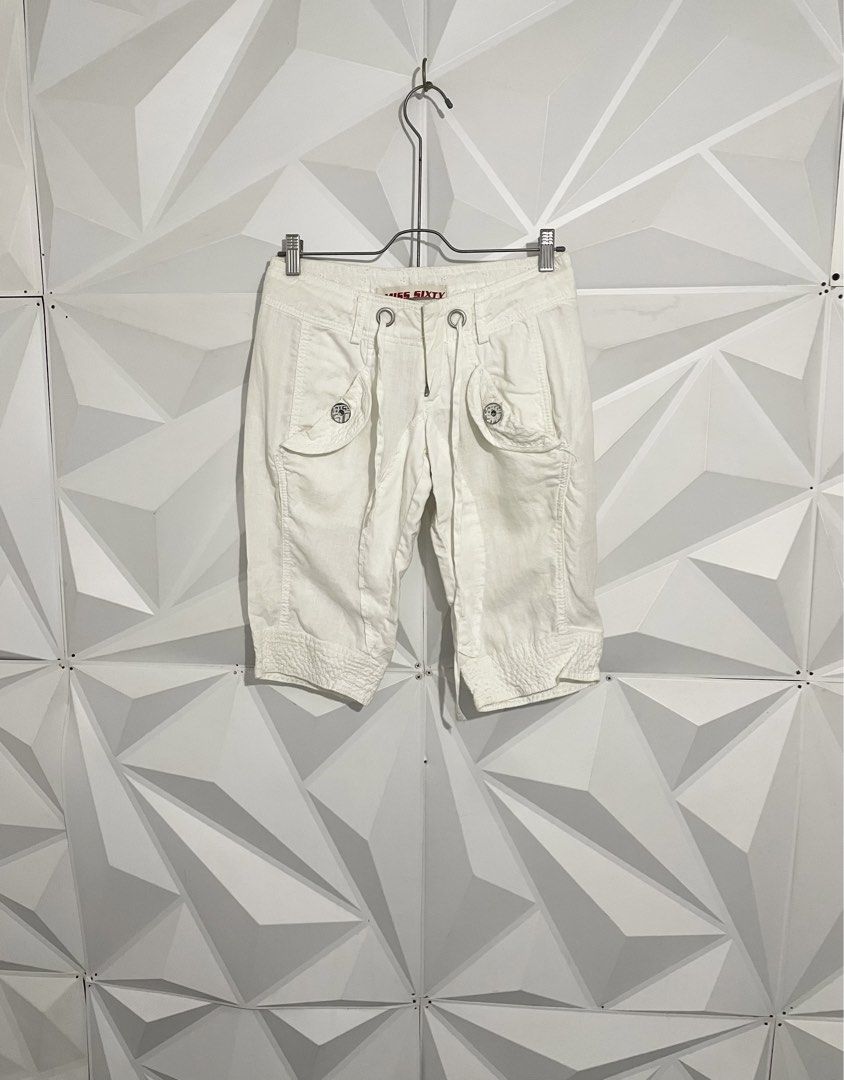 Y2k Miss Sixty White Capri Shorts (Category: Shorts) located in Cabuyao City. Submitted by ParadisethriftedPh (Listing ID 1470651147, Image 3). Description: Cr: 9.5/10 Dimensions Waist: 28-30 Length: 20 - Brand: Miss Sixty - Style: Y2K mid-rise capri shorts - Color: White - Waist: Adjustable drawstring with metal grommets - Details: Front flap pockets, branded metal buttons, pleated front leg seams, textured hem cuffs - Back: Authentic Miss Sixty