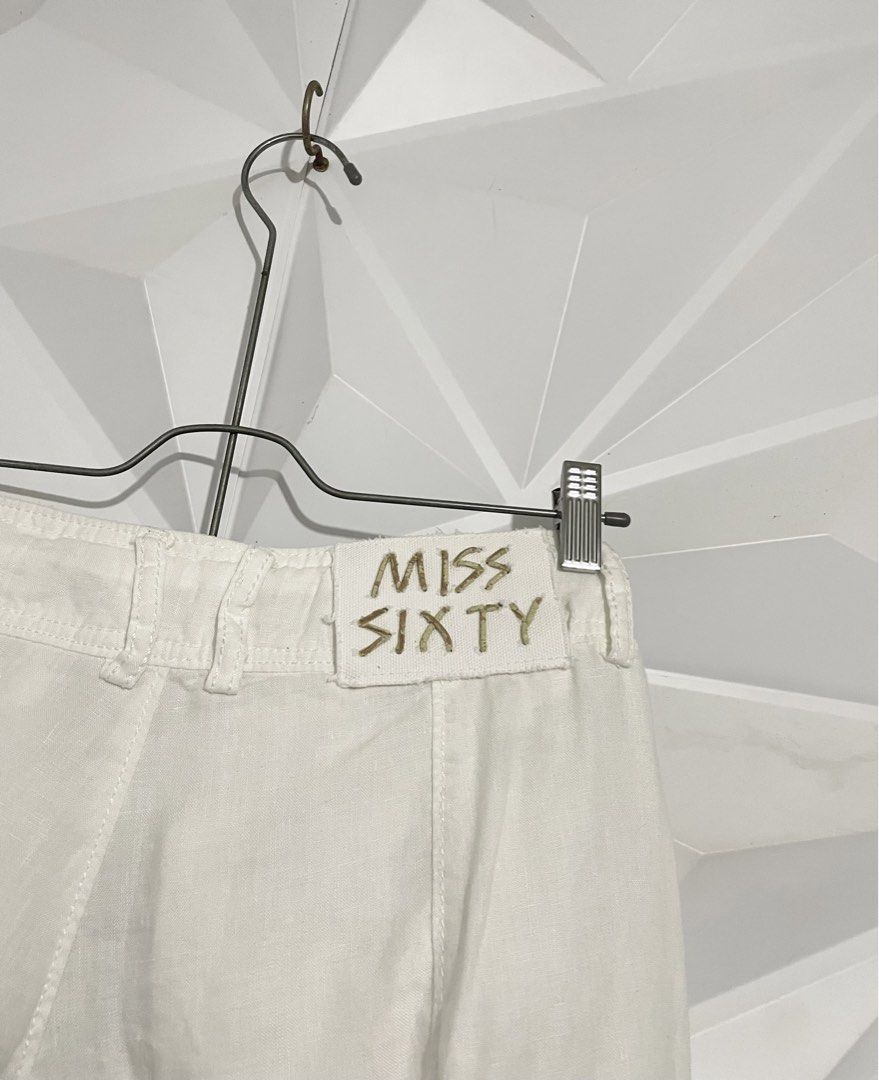 Y2k Miss Sixty White Capri Shorts (Category: Shorts) located in Cabuyao City. Submitted by ParadisethriftedPh (Listing ID 1470651147, Image 2). Description: Cr: 9.5/10 Dimensions Waist: 28-30 Length: 20 - Brand: Miss Sixty - Style: Y2K mid-rise capri shorts - Color: White - Waist: Adjustable drawstring with metal grommets - Details: Front flap pockets, branded metal buttons, pleated front leg seams, textured hem cuffs - Back: Authentic Miss Sixty