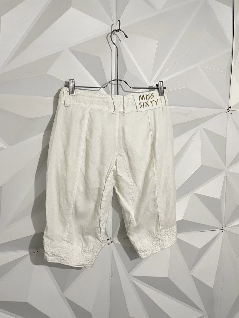 Y2k Miss Sixty White Capri Shorts (Category: Shorts) located in Cabuyao City. Submitted by ParadisethriftedPh (Listing ID 1470651147, Image 1). Description: Cr: 9.5/10 Dimensions Waist: 28-30 Length: 20 - Brand: Miss Sixty - Style: Y2K mid-rise capri shorts - Color: White - Waist: Adjustable drawstring with metal grommets - Details: Front flap pockets, branded metal buttons, pleated front leg seams, textured hem cuffs - Back: Authentic Miss Sixty