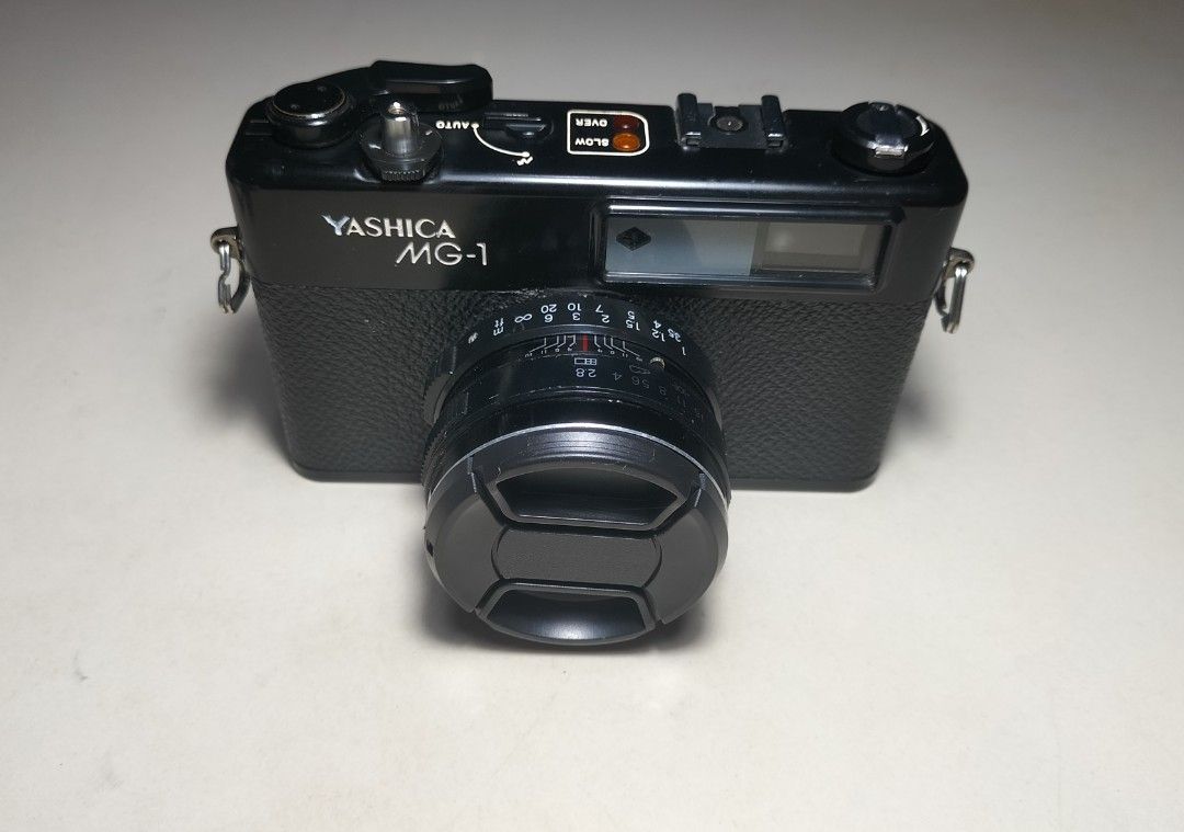 Yashica MG-1 Rangefinder Film Camera (Category: Cameras) located in Paranaque City. Submitted by zenfalcon.e8286d (Listing ID 1470567953, Image 2). Description: Ready to use... -Good working condition -Clad recently -Clean lens&VF/RFpatch- ok -Exposure: Auto Aperture priority(Accurate) -Slow/Over signal (works) -Working timer -Has light seals -Comes with battery and adapter,generic lenscap and strap - Presentable... .