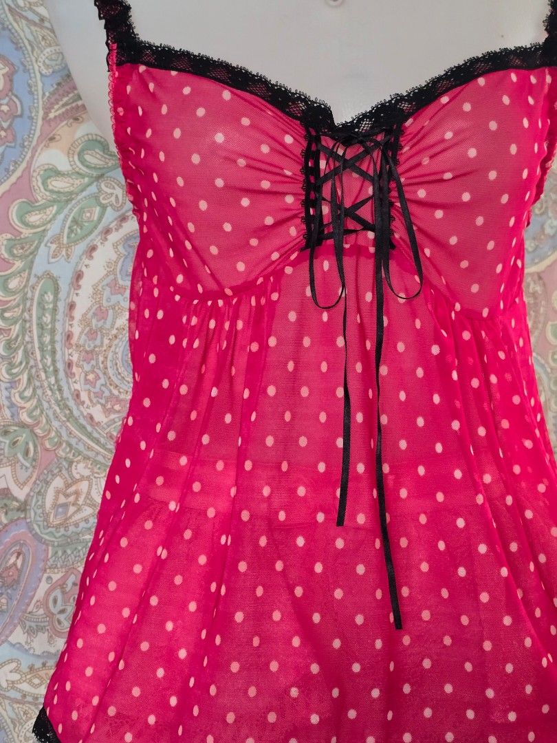 Yi Legend Pink Polka Dot Camisole Size M (Category: Sleeveless) located in Dagupan City. Submitted by chislocker14 (Listing ID 1470598257, Image 2). Description: - Brand: Yi Legend - Size: M - Design: Pink polka dot sheer mesh camisole - Details: Black lace trim, front lace-up with black ribbons.