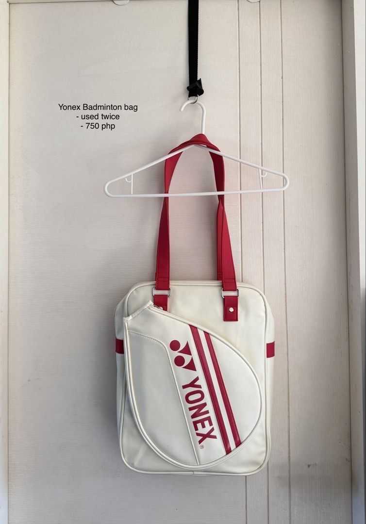 Yonex Badminton Bag White and Red (Category: Racket and Ball Sports) located in Manila. Submitted by cinnmoroll (Listing ID 1470608295, Image 1). Description: Yonex badminton bag in white with red straps and accents. Classic racket-shaped front pocket design with large printed Yonex branding. Used twice only, practically spotless inside and out. Dual shoulder straps for easy carry to the court. Sturdy material keeps gear protected..