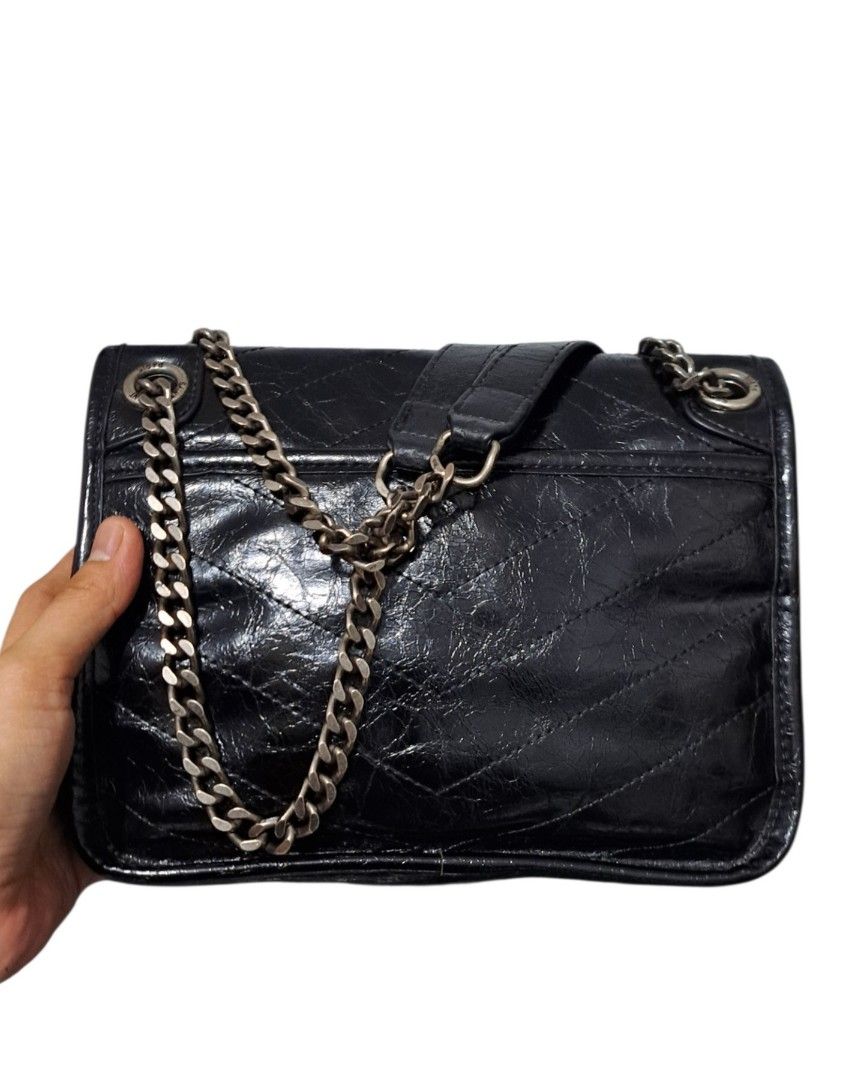 YSL Shoulder Bag (Category: Shoulder Bags) located in Quezon City. Submitted by kirstenbella (Listing ID 1470644164, Image 3). Description: YSL Niki Shoulder Bag in black quilted vintage crinkled calfskin leather. - Black quilted vintage crinkled calfskin leather with chevron quilting - Matching black finish with iconic YSL monogram - Dual chain & leather straps plus a convenient top handle - Magnetic snap front flap - Fabric-lined interior with 