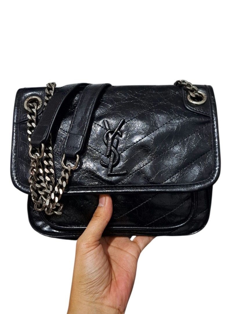 YSL Shoulder Bag (Category: Shoulder Bags) located in Quezon City. Submitted by kirstenbella (Listing ID 1470644164, Image 1). Description: YSL Niki Shoulder Bag in black quilted vintage crinkled calfskin leather. - Black quilted vintage crinkled calfskin leather with chevron quilting - Matching black finish with iconic YSL monogram - Dual chain & leather straps plus a convenient top handle - Magnetic snap front flap - Fabric-lined interior with 
