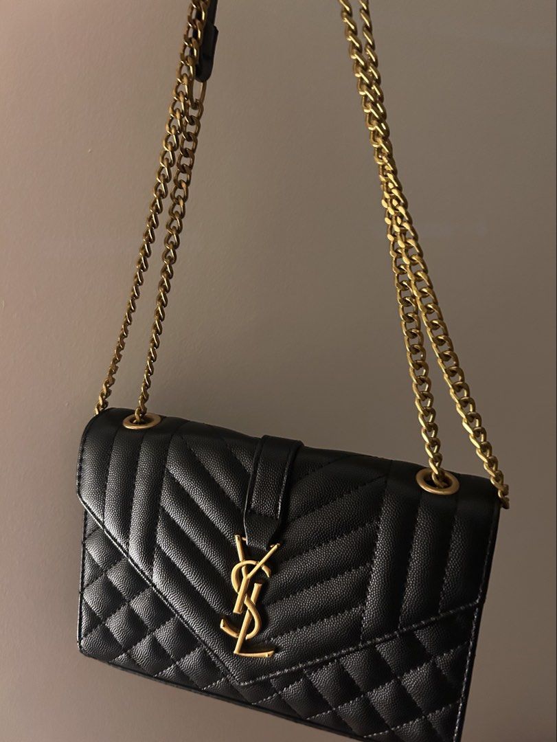 YSL shoulder bag / wallet on chain (Category: Cross-body Bags) located in Makati City. Submitted by ladybugsie (Listing ID 1470718256, Image 1). Description: Style it in many ways! As shoulder bag or cross body. Minimal chipping of leather on the right flap (refer to last photo).