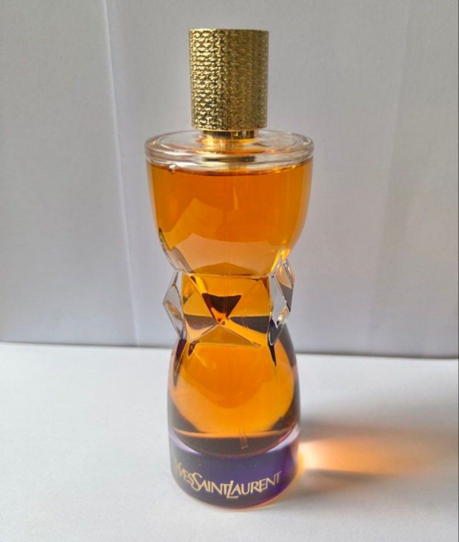 Yves Saint Laurent Eau de Parfum 100ml (Category: Fragrance & Deodorants) located in Santa Rosa. Submitted by chindeclutters (Listing ID 1470564974, Image 1). Description: - Brand: Yves Saint Laurent (YSL) Eau de Parfum - Size: 3.4 fl oz / 100 ml (Full bottle) - Bottle: Iconic hourglass shape with a textured gold cap - Details: Batch code 14150, made in USA by Interparfums - Fragrance: Rich amber color visible inside - Condition: Almost full, ide
