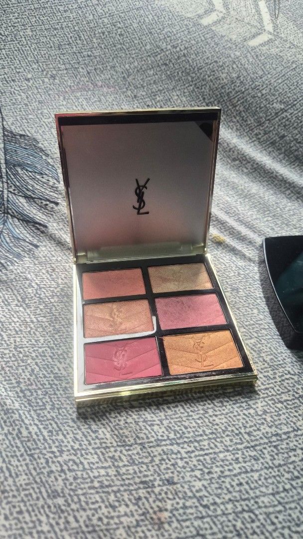 Yves Saint Laurent Makeup Palette (Category: Makeup) located in Manila. Submitted by corradelar45849 (Listing ID 1470597099, Image 1). Description: - Brand: Yves Saint Laurent (YSL) - Design: Quilted beige cover with iconic gold Cassandre logo and built-in mirror - Shades: 6 versatile colors ranging from gold, bronze, to pink tones - Condition: Minimal usage, with original powder embossing still intact on several pans - Portability: Compact size,