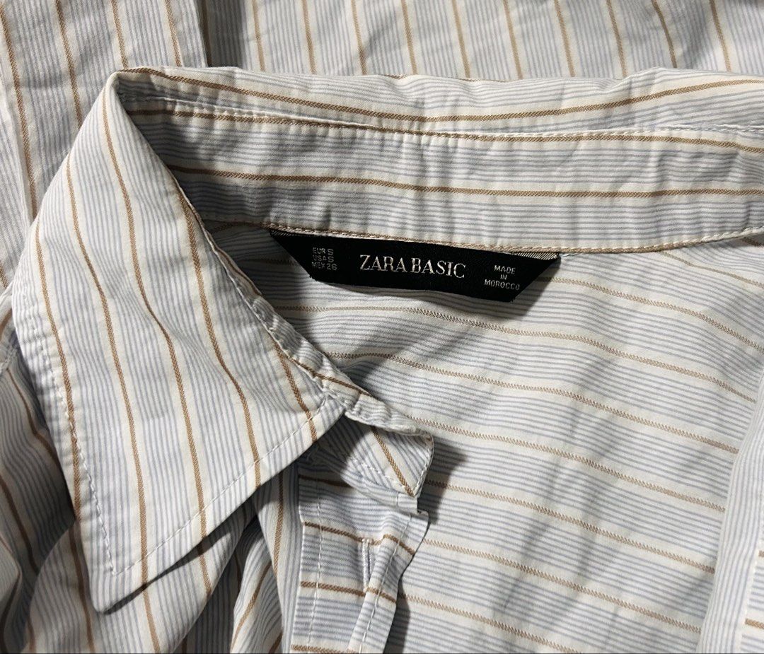 ZARA (Category: Shirts) located in Davao. Submitted by sart0ria85 (Listing ID 1470613381, Image 3). Description: Light blue and brown stripes with classic collar and curved hem. Relaxed, oversized fit. 50% COTTON 42% POLYESTER 8% VISCOSE MADE IN MOROCCO 🇲🇦 SMALL. Size 4 Oversize and also perfect for Medium to Large. EXCELLENT CONDITION (92/100).