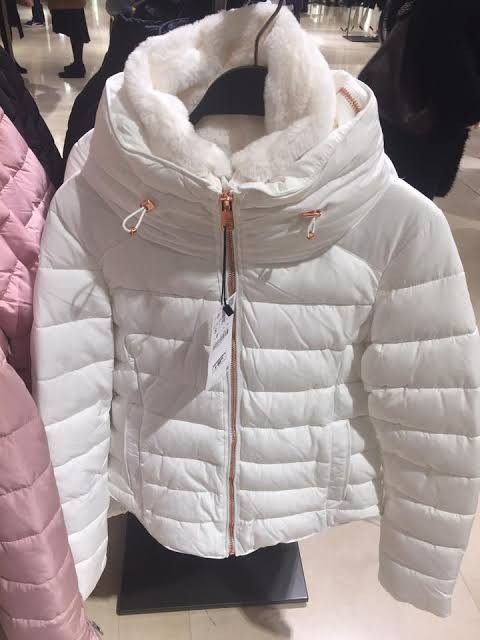 Zara Basic White Puffer Jacket with Faux Fur Hood (Category: Coats, Jackets and Outerwear) located in Manila. Submitted by jhenniegir36703 (Listing ID 1470634179, Image 1). Description: - Brand: Zara Basic - Color: White - Style: Quilted puffer jacket with high collar - Details: Fluffy faux fur lining on the collar, rose gold zippers on front and cuffs - Condition: Great, clean with no stains or damage - Perfect for cold weather.
