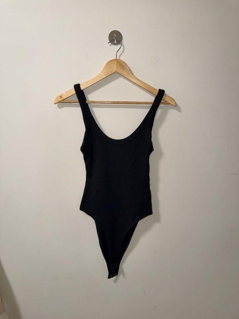 Zara Black Ribbed Bodysuit Size M (Category: Sleeveless) located in Makati City. Submitted by andzr. (Listing ID 1470642371, Image 1). Description: - Brand: Zara - Style: Ribbed black bodysuit - Details: Scoop neckline, thick tank straps, snap button closure - Fit: Stretchy, snug, and comfortable - Size: M - Condition: Clean and ready to wear.