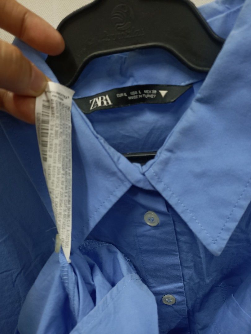 Zara Blue Oversized Button-Up Shirt Size L (Category: Longsleeves) located in Bayombong. Submitted by rheaaa00530 (Listing ID 1470671415, Image 2). Description: - Brand: Zara - Color: Light blue - Size: EUR L / USA L / MEX 30 - Material: 100% Cotton (Made in Turkey) - Fit: Relaxed, oversized fit - Features: Classic collar, long sleeves, single chest pocket, buttoned cuffs - Condition: Great casual staple piece, easy to style tucked in or worn loo
