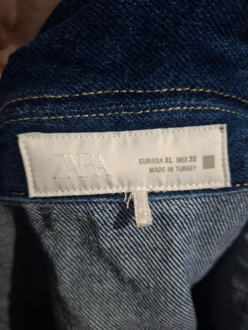 ZARA Dark Blue Denim Jacket Size XL (Category: Coats, Jackets and Outerwear) located in Manila. Submitted by enrich_mj (Listing ID 1470681483, Image 3). Description: - Brand: Zara - Origin: Made in Turkey - Size: EUR/USA XL / MEX 32 - Color: Dark Blue - Material: Heavy denim, ideal for layering - Features: Front button closure, two front chest pockets, classic collar style - Condition: Great staple outerwear piece.