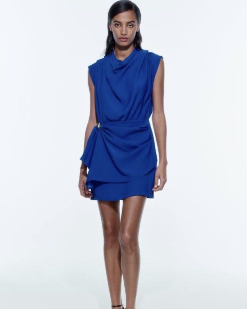 Zara Royal Blue Draped Dress (Category: Dresses) located in Makati City. Submitted by purewind.a22dcd (Listing ID 1470594167, Image 1). Description: - Brand: Zara (Brand tag and original store tags still attached) - Color: Bright royal blue - Style: Sleeveless with gathered front draping and a flowy fit - Details: Unique silver-tone accent ring at the waistline and back collar button closure - Condition: Brand new, never worn.