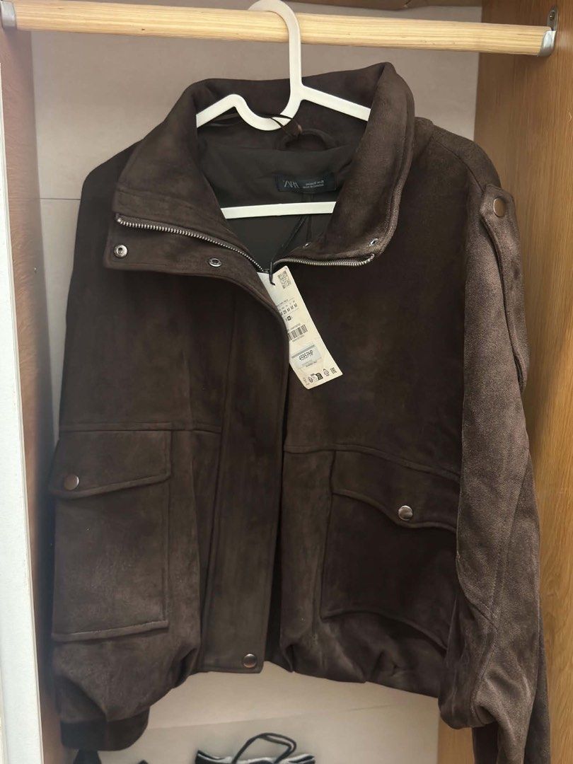 Zara Suede Jacket With Tabs Brown Size M (Category: Coats, Jackets and Outerwear) located in Manila. Submitted by M0detackle (Listing ID 1470679488, Image 2). Description: - Brand: Zara - Condition: Brand new with tags (Never worn) - Size: Medium (M) - Color: Dark Brown - Material: Soft faux suede - Features: High collar, zipper with snap button closure, front patch pockets, and shoulder tabs - Fit: Structured fit.