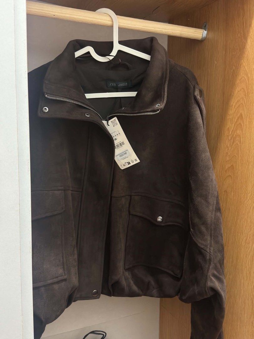 Zara Suede Jacket With Tabs Brown Size M (Category: Coats, Jackets and Outerwear) located in Manila. Submitted by M0detackle (Listing ID 1470679488, Image 3). Description: - Brand: Zara - Condition: Brand new with tags (Never worn) - Size: Medium (M) - Color: Dark Brown - Material: Soft faux suede - Features: High collar, zipper with snap button closure, front patch pockets, and shoulder tabs - Fit: Structured fit.