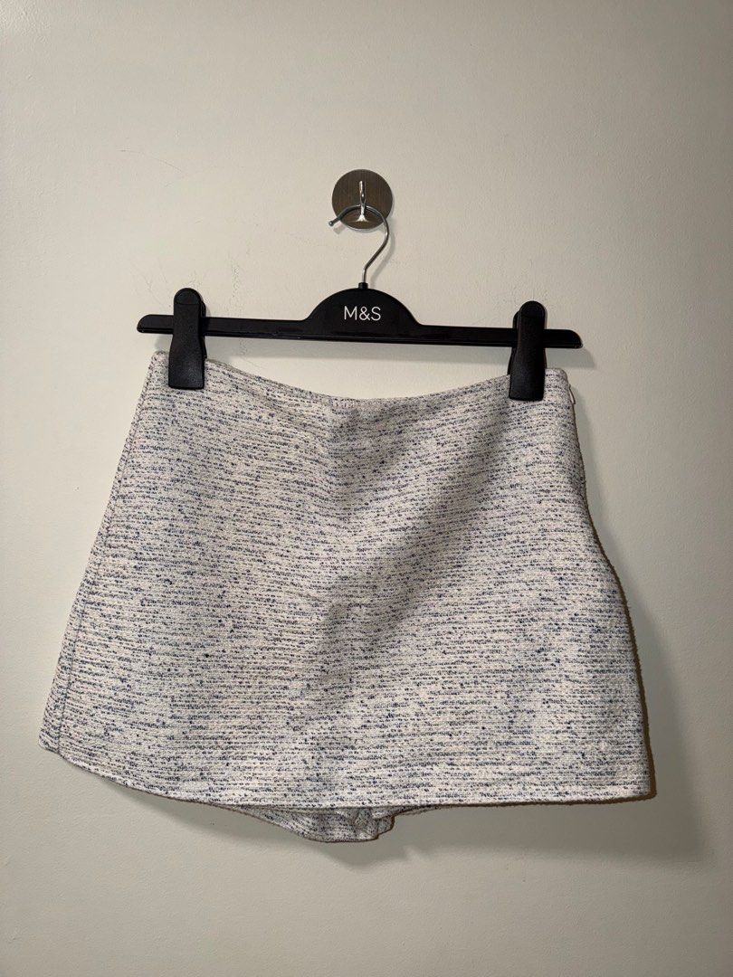 Zara Tweed Skort White Blue Size M (Category: Shorts) located in Makati City. Submitted by andzr. (Listing ID 1470643199, Image 1). Description: - Brand: Zara - Style: Tweed skort with stylish blue specks - Size: M - Fit: High-waisted - Details: Textured fabric, side zip closure - Condition: Clean all around, well-maintained.