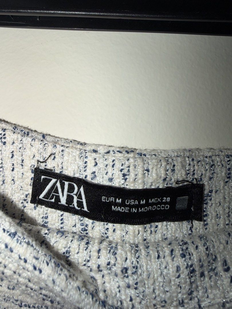Zara Tweed Skort White Blue Size M (Category: Shorts) located in Makati City. Submitted by andzr. (Listing ID 1470643199, Image 2). Description: - Brand: Zara - Style: Tweed skort with stylish blue specks - Size: M - Fit: High-waisted - Details: Textured fabric, side zip closure - Condition: Clean all around, well-maintained.