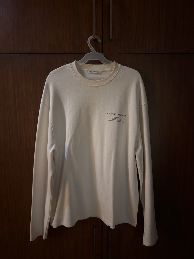 Zara Uncommon Aesthetic Long Sleeve Tee (Category: Tshirts & Polo Shirts ) located in Manila. Submitted by preloved123. (Listing ID 1470713796, Image 1). Description: - Brand: Zara - Color: Cream/White - Size: L - Material/Origin: Made in Bangladesh - Design: 'Uncommon Aesthetic' print on left chest, clean solid back - Fit: Relaxed fit with crew neck.