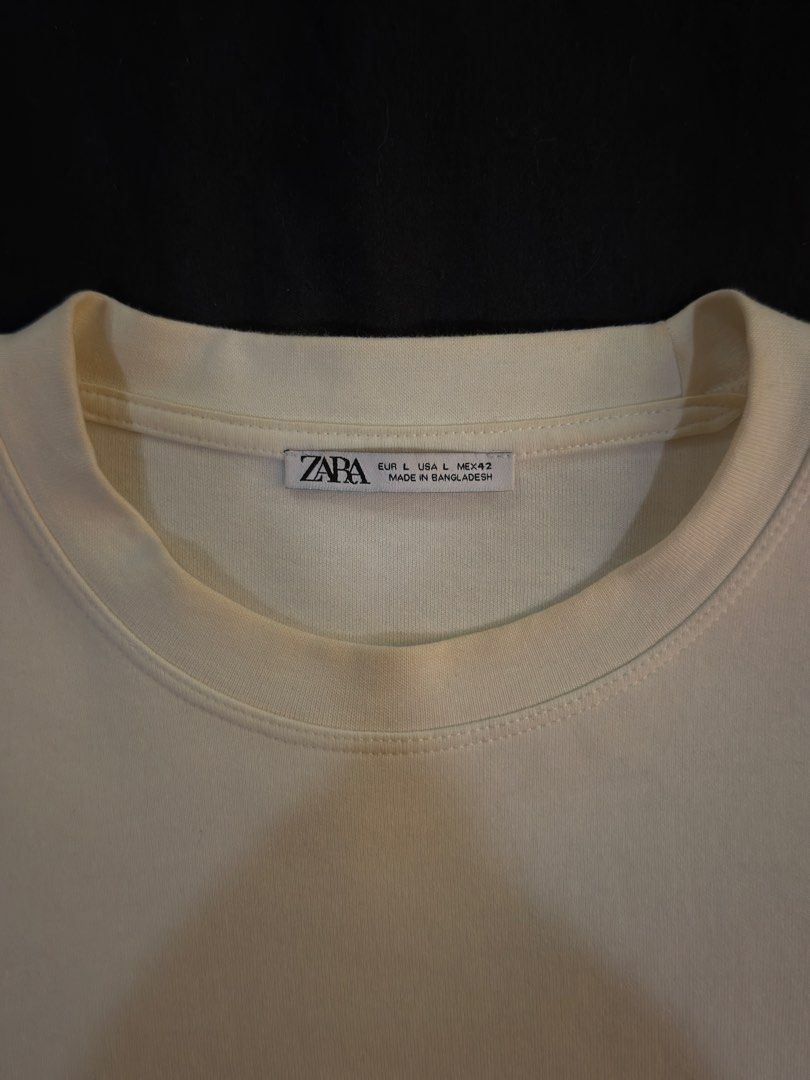 ZARA Uncommon Aesthetic Long Sleeve Tee (Category: Hoodies) located in Paranaque City. Submitted by preloveditems111 (Listing ID 1470716387, Image 3). Description: - Brand: ZARA - Color: Off-white - Size: Large - Material: 100% Soft Cotton (Made in Bangladesh) - Design: Graphic text 'UNCOMMON AESTHETIC' on left chest, clean solid back - Fit: Relaxed fit with crew neck collar - Condition: Great for comfortable daily wear.