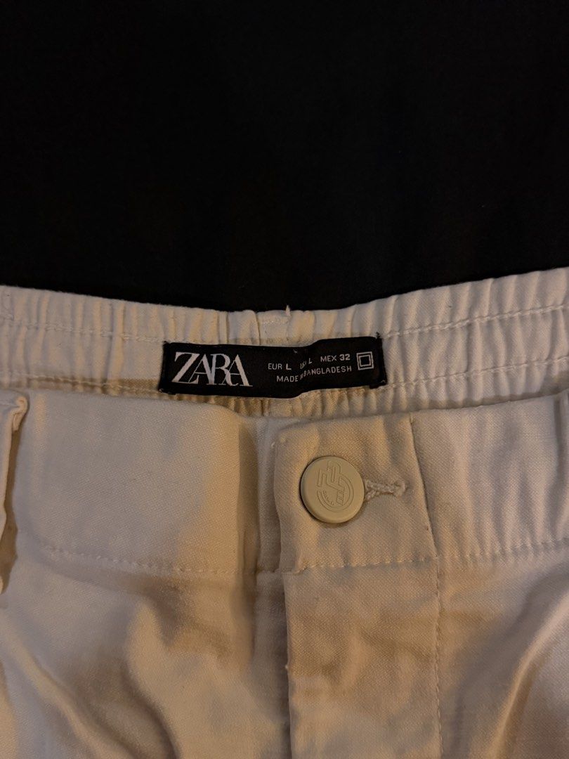 Zara White Carpenter Pants Size L (Category: Jeans) located in Manila. Submitted by preloved123. (Listing ID 1470717397, Image 3). Description: - Brand: Zara - Style: White carpenter pants with utility pockets and hammer loop - Fit: Relaxed fit with elastic waistband in the back, button closure, and zip fly - Material: Thick, durable cotton - Origin: Made in Bangladesh - Size: EUR L / USA L / MEX 32 - Condition: Great streetwear staple for everyd