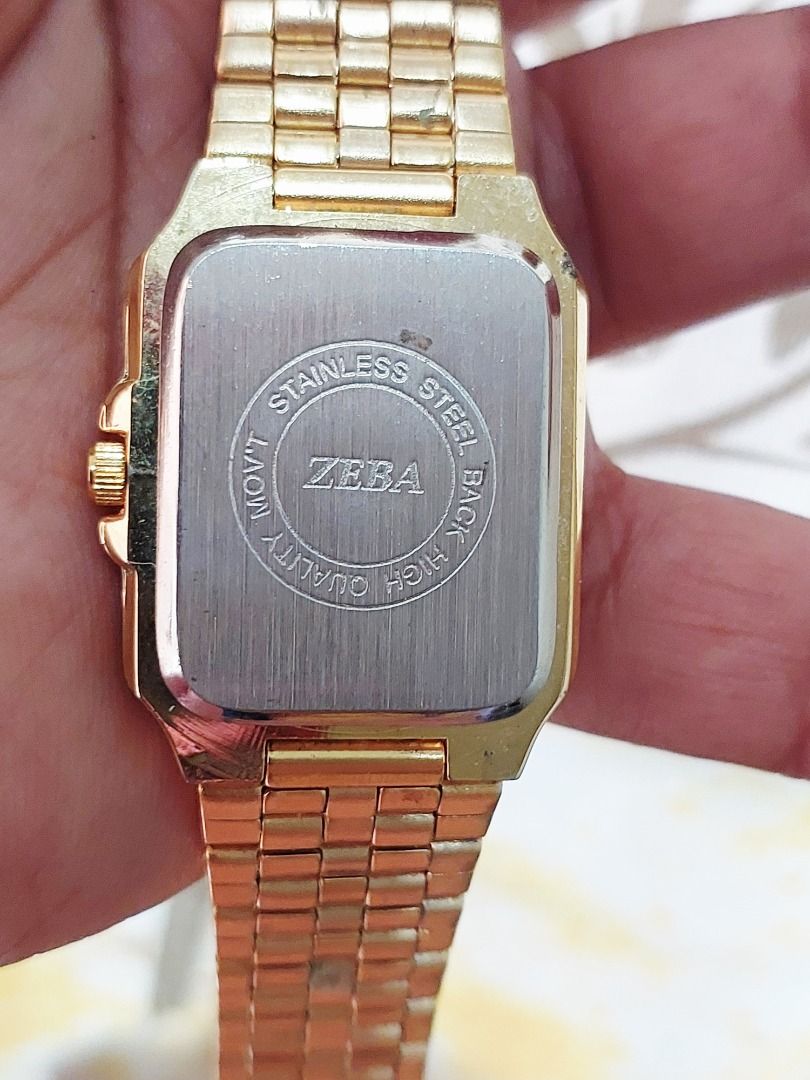 ZEBA Gold Quartz Watch with Rectangular Dial (Category: Women's Watches) located in Batangas. Submitted by vintageanddainty (Listing ID 1470586590, Image 3). Description: - Brand: ZEBA - Style: Gold-tone watch with rectangular face - Dial: Clean white dial with black Arabic numerals and gold hands - Movement: Reliable quartz movement for accurate timekeeping - Strap: Matching gold metal link bracelet with secure clasp - Details: Stainless steel c