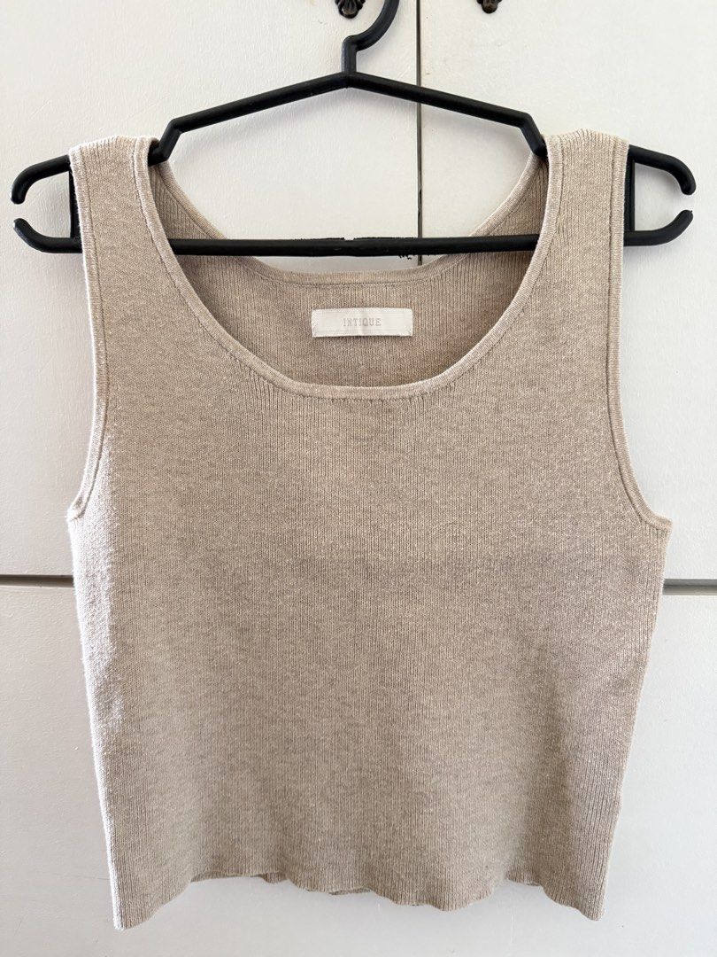 100% Cotton Knit Tank Top Beige (Category: Sleeveless) located in Manila. Submitted by mnlclaudia (Listing ID 1470790750, Image 1). Description: - Brand: INTIQUE - Material: 100% Cotton - Color: Neutral beige - Design: Scoop neck, sleeveless, soft ribbed knit texture - Style: Versatile basic, perfect for pairing with jeans or skirts - Condition: Brand new / Excellent.