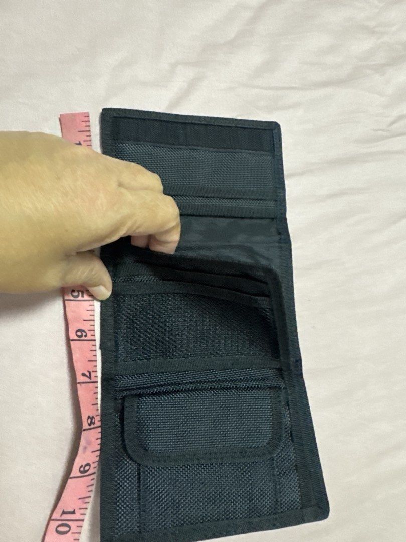 2027 BD Puma Black Trifold Wallet (Category: Wallets & Card Holders) located in Silang. Submitted by sari2bilina (Listing ID 1470889981, Image 3). Description: - Brand: Puma - Color: Black with white logo and grey curved design - Material: Durable nylon - Closure: Secure velcro - Interior: Multiple card slots, mesh pockets, and a zippered coin compartment - Dimensions: Approx. 4.5 x 3 inches (folded) - Condition: Brand new / Excellent quality - P
