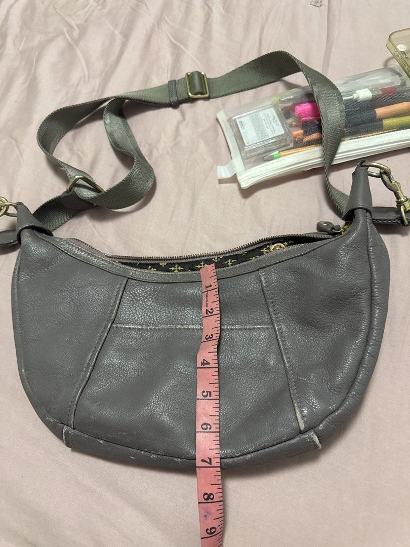 2027 BD Russet grey leather shoulder bag with adjustable strap (Category: Shoulder Bags) located in Silang. Submitted by sari2bilina (Listing ID 1470885798, Image 1). Description: Grey leather shoulder bag from Russet. Measures roughly 9 inches by 15 inches with about 4 inches width. Outer material is genuine textured leather with visible scuffs and wear along the bottom edges and corners. Zip top closure opens to a patterned dark fabric lining a