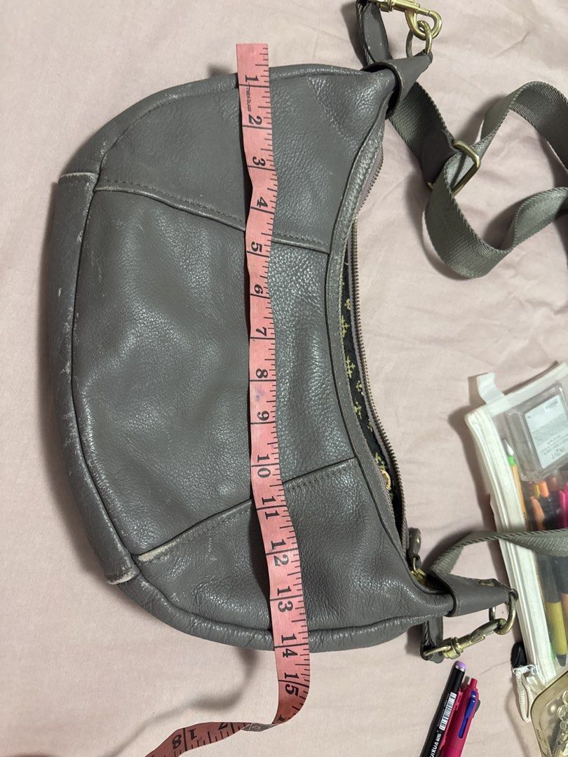 2027 BD Russet grey leather shoulder bag with adjustable strap (Category: Shoulder Bags) located in Silang. Submitted by sari2bilina (Listing ID 1470885798, Image 2). Description: Grey leather shoulder bag from Russet. Measures roughly 9 inches by 15 inches with about 4 inches width. Outer material is genuine textured leather with visible scuffs and wear along the bottom edges and corners. Zip top closure opens to a patterned dark fabric lining a