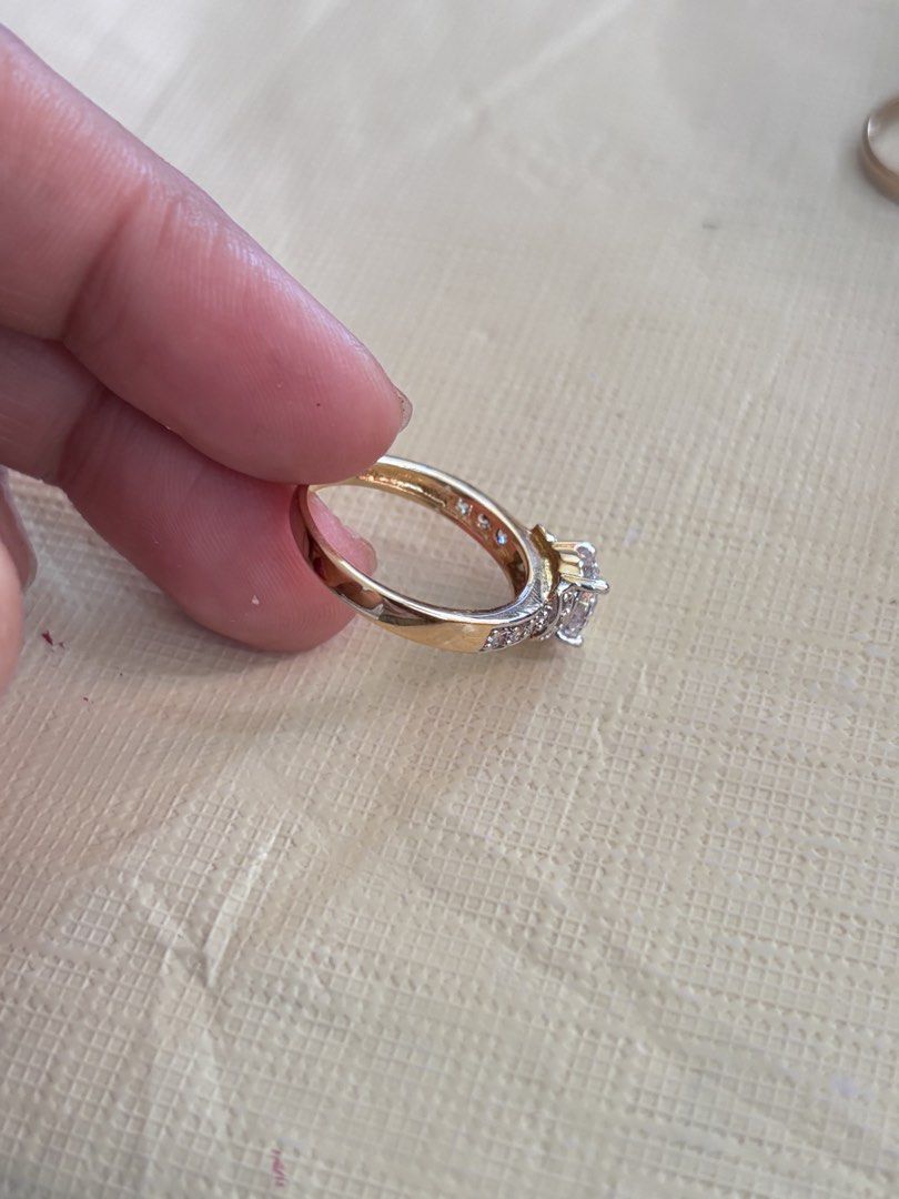 2 tone Solitaire Diamond Ring with Pave Band (Category: Rings) located in Dagupan City. Submitted by bookishpill (Listing ID 1470837728, Image 2). Description: Non pawnable looks real gold Size 6.5 - Elegant yellow gold ring with a classic, shiny finish - Features a stunning large center stone as the main focal point - Adorned with small, sparkling crystals along the band - Clean metal shank with secure stone settings - Fits standard ring sizes p