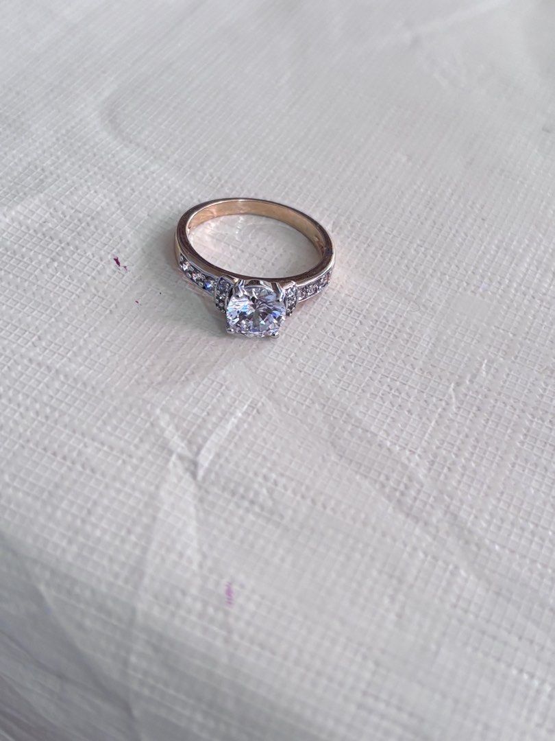2 tone Solitaire Diamond Ring with Pave Band (Category: Rings) located in Dagupan City. Submitted by bookishpill (Listing ID 1470837728, Image 3). Description: Non pawnable looks real gold Size 6.5 - Elegant yellow gold ring with a classic, shiny finish - Features a stunning large center stone as the main focal point - Adorned with small, sparkling crystals along the band - Clean metal shank with secure stone settings - Fits standard ring sizes p