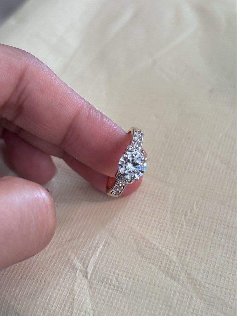 2 tone Solitaire Diamond Ring with Pave Band (Category: Rings) located in Dagupan City. Submitted by bookishpill (Listing ID 1470837728, Image 1). Description: Non pawnable looks real gold Size 6.5 - Elegant yellow gold ring with a classic, shiny finish - Features a stunning large center stone as the main focal point - Adorned with small, sparkling crystals along the band - Clean metal shank with secure stone settings - Fits standard ring sizes p