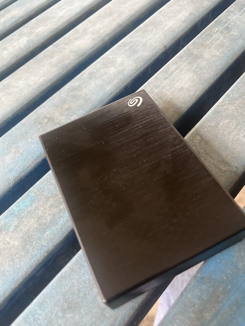 4TB SEAGATE HDD (Category: Hard Disks & Thumbdrives) located in Cavite. Submitted by bribr36803 (Listing ID 1470783865, Image 1). Description: - Brand: Seagate external hard drive 4tb - Color/Finish: Black with brushed metal finish - Included: Matching black Seagate zippered protective sleeve case - Portability: Compact size, easy to toss into a bag for backups on the go - Condition: Works great, zero issues.