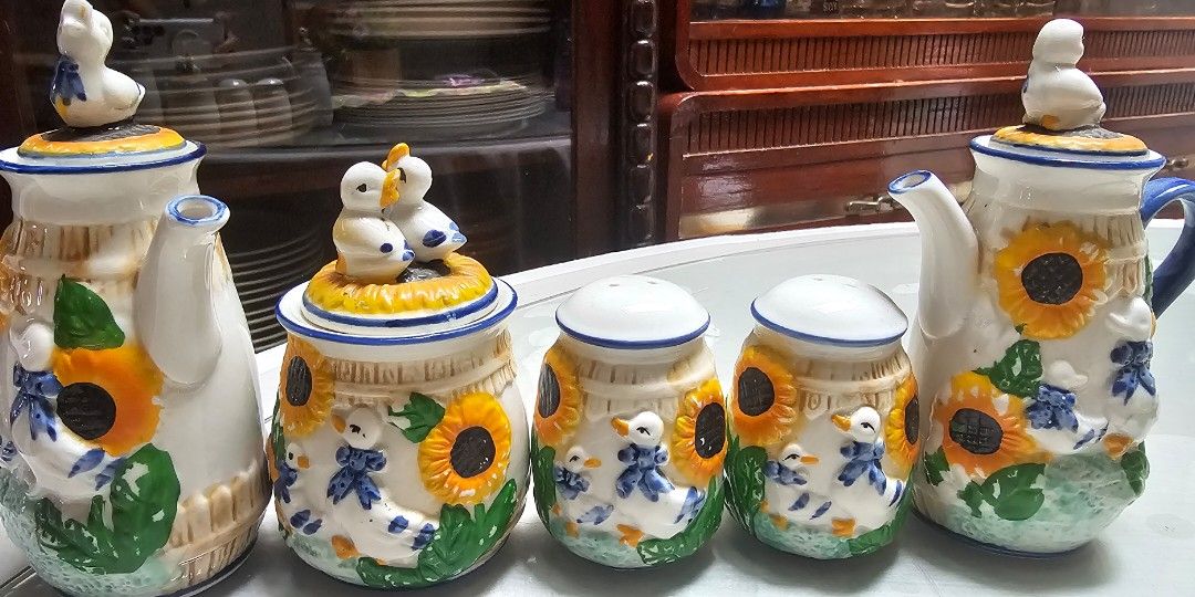 5-Piece Ceramic Sunflower & Duck Set (Category: Coffee & Tea Tableware) located in Pasig City. Submitted by bubbles108 (Listing ID 1470866842, Image 1). Description: Set includes: 2 ceramic teapots 1 decorative lidded jar with duck figurines 1 salt shaker 1 pepper shaker No chips or cracks Intricate raised floral and duck details No maker's mark or country of origin indicated Perfect for kitchen display, country-style decor, or anyone who loves u