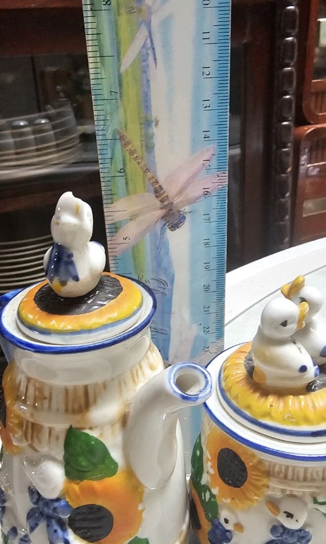 5-Piece Ceramic Sunflower & Duck Set (Category: Coffee & Tea Tableware) located in Pasig City. Submitted by bubbles108 (Listing ID 1470866842, Image 2). Description: Set includes: 2 ceramic teapots 1 decorative lidded jar with duck figurines 1 salt shaker 1 pepper shaker No chips or cracks Intricate raised floral and duck details No maker's mark or country of origin indicated Perfect for kitchen display, country-style decor, or anyone who loves u
