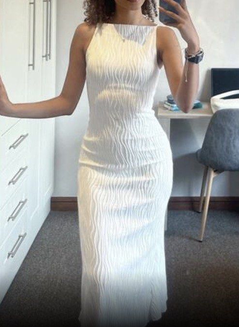 🦢 WHITE MAXI DRESS (Category: Dresses) located in Manila. Submitted by alionyyy (Listing ID 1470787498, Image 2). Description: 🪩 used only twice, can fit xs-s 📍 UST, MANILA - Color: White - Style: Sleeveless maxi dress with a clean, minimalist design - Fit: Slim bodycon fit that hugs curves down to the ankles - Details: All-over textured wavy pattern, straight boat neckline, and thin straps - Material: Stretchy and comfortable fabric - Ideal f