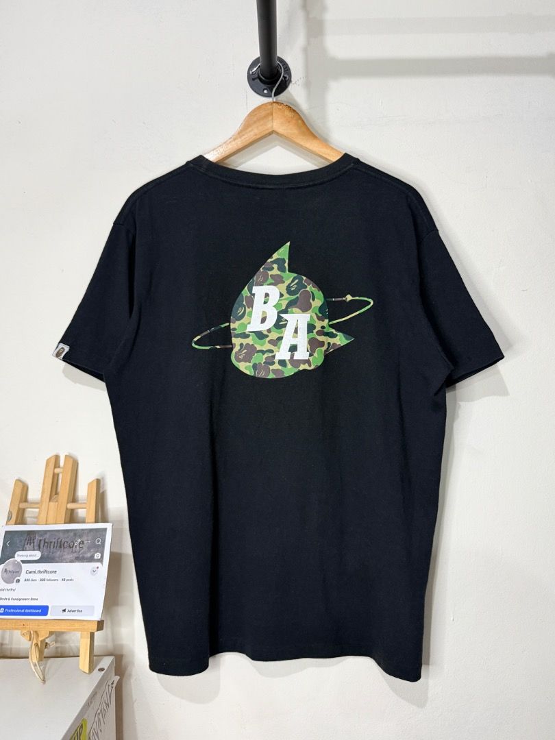 A Bathing Ape Astro Boy Black T-Shirt (Category: Tshirts & Polo Shirts ) located in Caloocan City. Submitted by choidelfin.420 (Listing ID 1470824006, Image 2). Description: - Brand: BAPE (A BATHING APE) x Astro Boy - Color: Classic Black - Style: Short sleeve crewneck graphic tee - Design: Iconic Astro Boy artwork with signature green camo accents on boots and typography - Size: 22x27 (pit-to-pit x length) - Condition: Neck tag intact with gold 