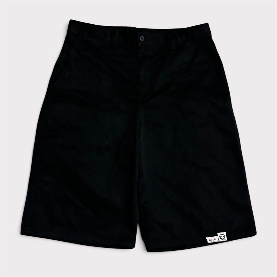 Aape Black Shorts (Category: Shorts) located in Manila. Submitted by jeproxthrift (Listing ID 1470922853, Image 1). Description: - Brand: Aape - Color: Black (Solid) - Style: Casual streetwear, straight leg cut - Features: Belt loops, front button closure, deep side pockets - Detail: Small woven Aape logo patch near bottom hem - Condition: Excellent / Clean throughout.
