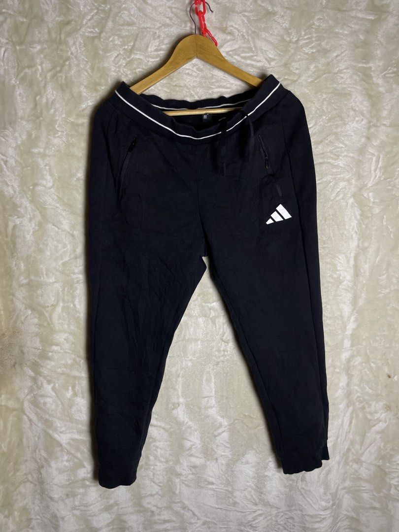Adidas Black Joggers Sweatpants (Category: Joggers) located in Molave. Submitted by charlesthrifter (Listing ID 1470853849, Image 1). Description: - Brand: adidas - Color: Black - Size: Medium (M) - Material: 67% cotton, 33% recycled polyester - Waistband: Striped elastic with adjustable drawstring - Pockets: Secure zippered pockets on both sides - Branding: Iconic white adidas logo on the left leg - Origin: Made in China - Condition: Brand new /