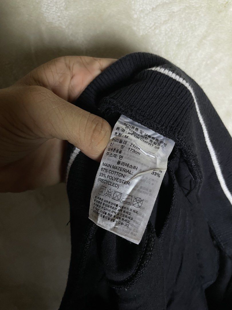 Adidas Black Joggers Sweatpants (Category: Joggers) located in Molave. Submitted by charlesthrifter (Listing ID 1470853849, Image 3). Description: - Brand: adidas - Color: Black - Size: Medium (M) - Material: 67% cotton, 33% recycled polyester - Waistband: Striped elastic with adjustable drawstring - Pockets: Secure zippered pockets on both sides - Branding: Iconic white adidas logo on the left leg - Origin: Made in China - Condition: Brand new /