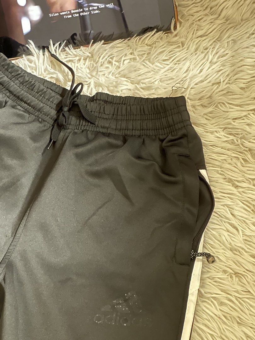 Adidas Black Track Pants with White Stripes (Category: Joggers) located in Taguig. Submitted by appatheseller (Listing ID 1470845897, Image 3). Description: Fits S-L - Authentic Adidas black track pants featuring signature white side stripes - Comfortable elastic waistband with adjustable drawstring - Secure zippered side pockets for your phone and essentials - Smooth, breathable fabric ideal for gym workouts or casual streetwear - Minimalist des