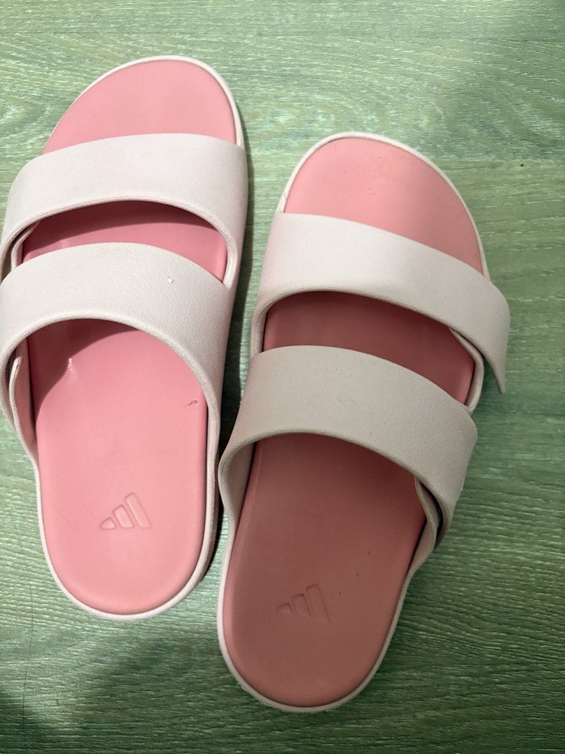 Adidas Cloudfoam Pink Double Strap Slides (Category: Flats & Sandals) located in Lapu-Lapu City. Submitted by sarahleeshop (Listing ID 1470835054, Image 1). Description: - Brand: Adidas - Style: Double-strap slip-on slides - Color: Light pink with debossed logo branding - Comfort: Cloudfoam molded cushioning for maximum comfort - Condition: Great casual wear with very minimal signs of wear on the footbed - Ideal for: Running errands or lounging a