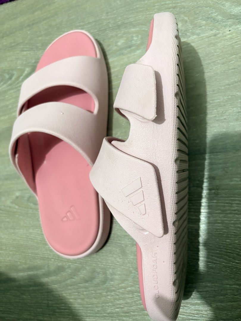 Adidas Cloudfoam Pink Double Strap Slides (Category: Flats & Sandals) located in Lapu-Lapu City. Submitted by sarahleeshop (Listing ID 1470835054, Image 2). Description: - Brand: Adidas - Style: Double-strap slip-on slides - Color: Light pink with debossed logo branding - Comfort: Cloudfoam molded cushioning for maximum comfort - Condition: Great casual wear with very minimal signs of wear on the footbed - Ideal for: Running errands or lounging a