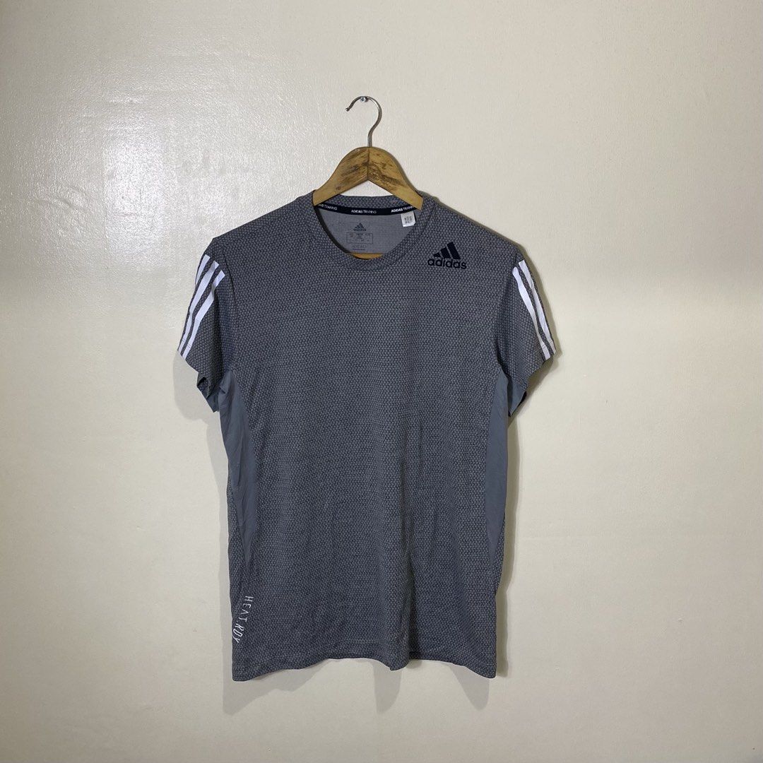 Adidas heat.rdy Training 3-Stripes Tee (Category: Tshirts & Polo Shirts ) located in Cebu City. Submitted by theloose.thread (Listing ID 1470917886, Image 1). Description: - Brand: Adidas - Style: Training t-shirt with crew neck and short sleeves - Color: Grey with iconic white 3-stripes - Size: Men's Medium (Regular fit) - Tech: Heat.RDY technology for cooling during workouts - Material: 100% recycled polyester main, 90% recycled polyester / 10%