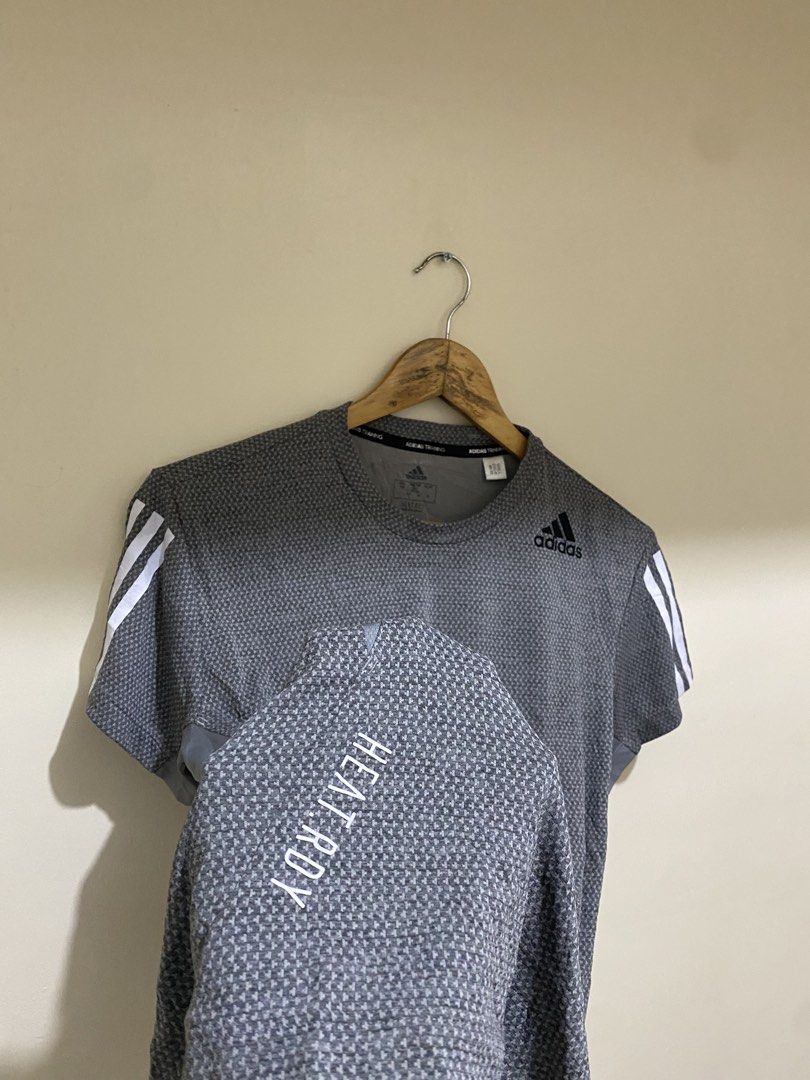 Adidas heat.rdy Training 3-Stripes Tee (Category: Tshirts & Polo Shirts ) located in Cebu City. Submitted by theloose.thread (Listing ID 1470917886, Image 2). Description: - Brand: Adidas - Style: Training t-shirt with crew neck and short sleeves - Color: Grey with iconic white 3-stripes - Size: Men's Medium (Regular fit) - Tech: Heat.RDY technology for cooling during workouts - Material: 100% recycled polyester main, 90% recycled polyester / 10%