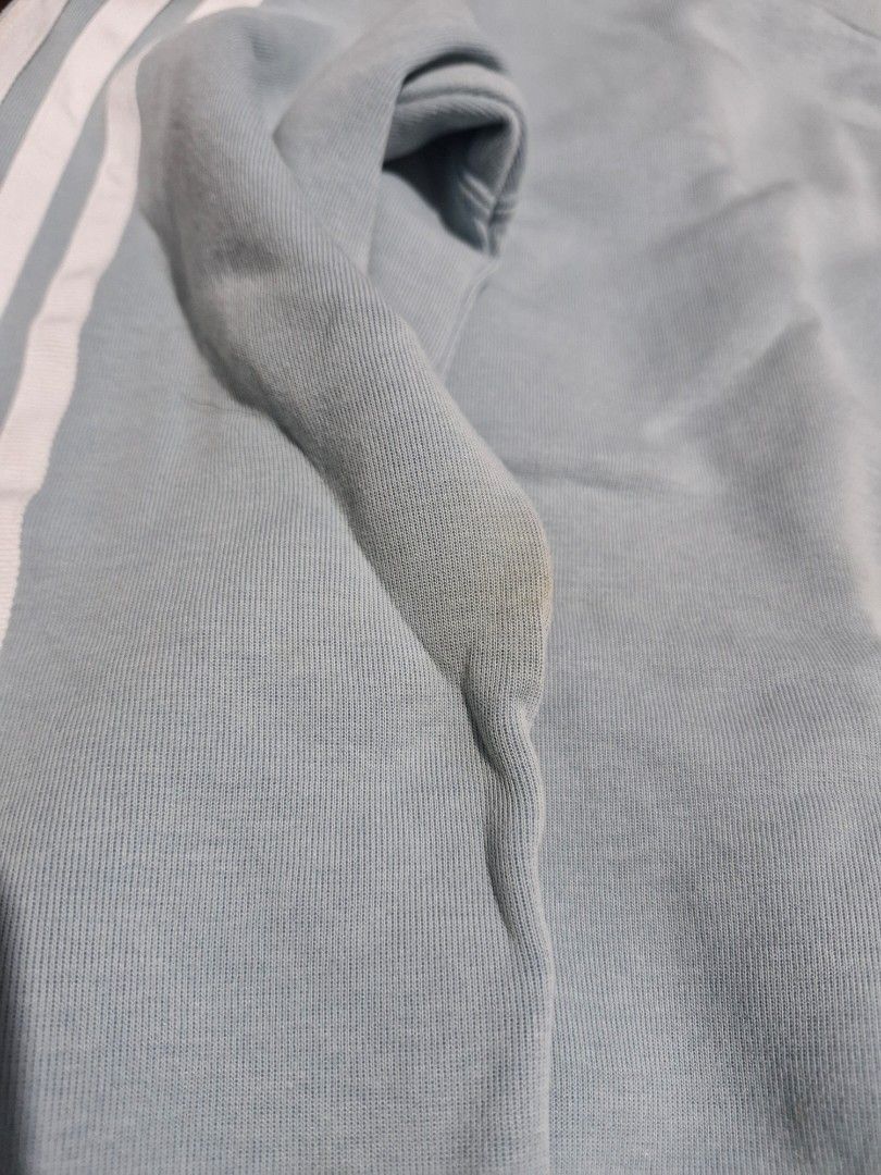 Adidas Light Blue Three Stripe Crewneck Sweatshirt (Category: Coats, Jackets and Outerwear) located in Manila. Submitted by martinezjonill (Listing ID 1470885823, Image 2). Description: - Brand: Adidas - Style: Crewneck sweatshirt - Color: Light blue with classic white three stripes - Details: Small embroidered trefoil logo on chest, ribbed cuffs, collar, and hem - Condition: Great casual piece, but has a slight yellowish stain on the right sleev